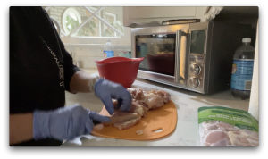 trimming fat off chicken thighs before cooking on big green egg